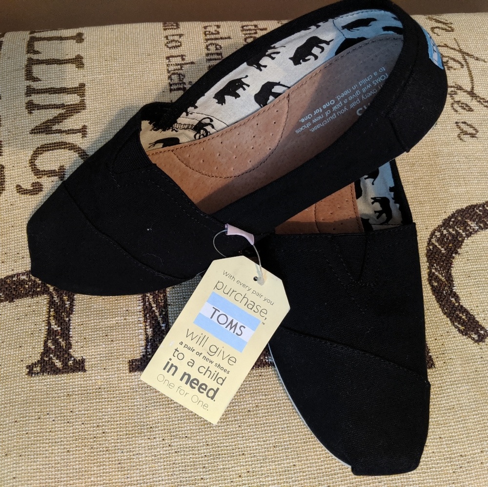 Tom's black slip-on shoes